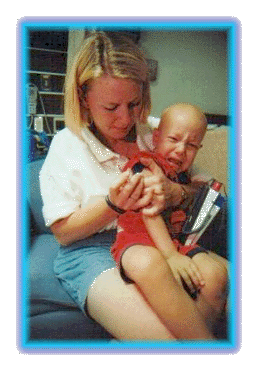 Mom giving Sebastian his shot that stimulates his bone marrow to product new blood cells.